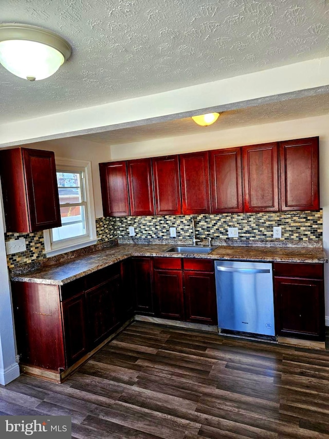 kitchen featuring dishwasher, sink, dark hardwood / wood-style floors, and decorative backsplash