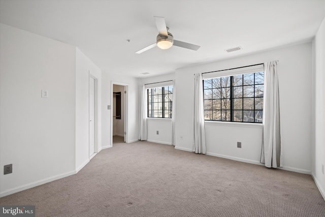 unfurnished room featuring light colored carpet and ceiling fan