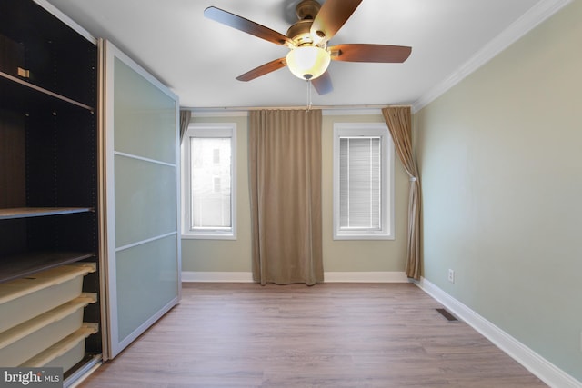 unfurnished bedroom with crown molding, ceiling fan, and light hardwood / wood-style floors