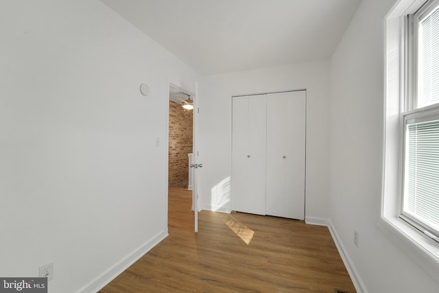 unfurnished bedroom featuring hardwood / wood-style flooring and a closet