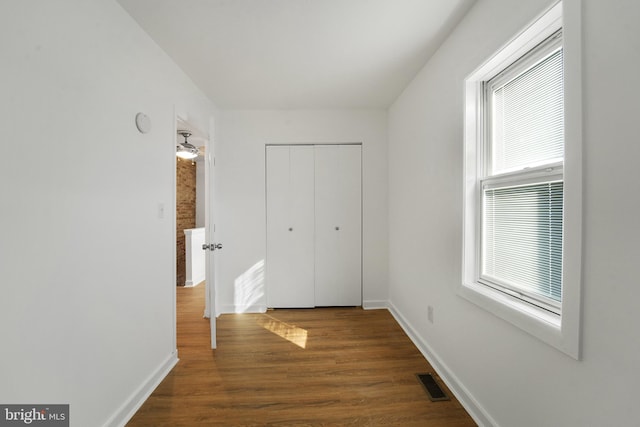 hall with dark wood-type flooring