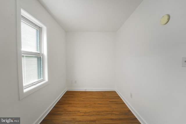 empty room with dark hardwood / wood-style floors