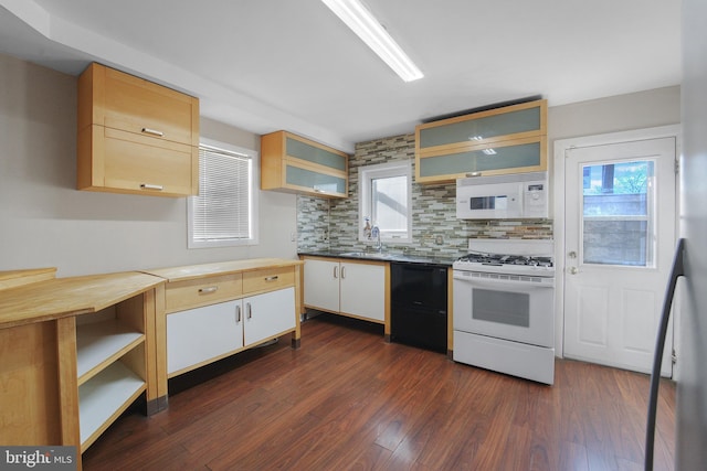 kitchen with sink, white appliances, white cabinetry, dark hardwood / wood-style floors, and tasteful backsplash