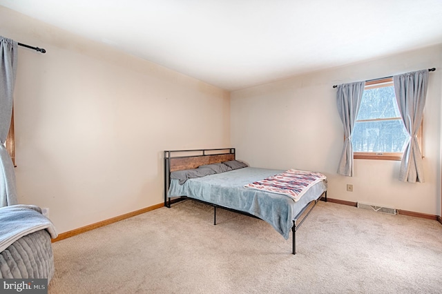 bedroom with light colored carpet