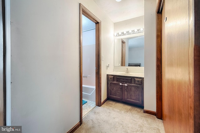 corridor featuring sink and light colored carpet