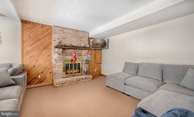 carpeted living room with a brick fireplace, a textured ceiling, and wood walls