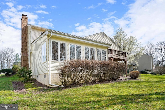 view of home's exterior with a lawn