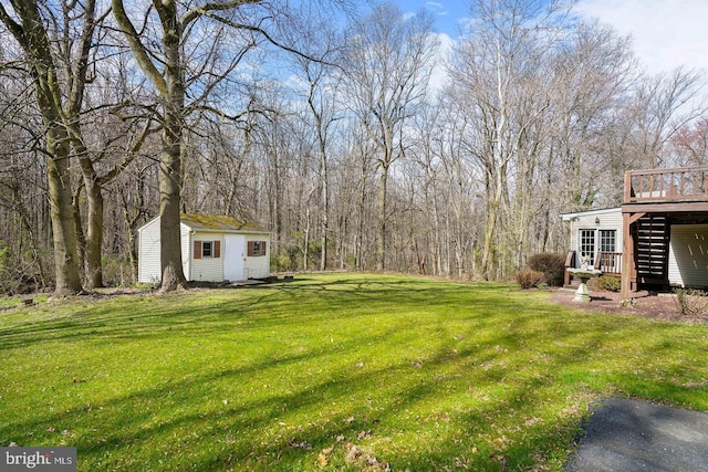 view of yard with a storage shed and a deck