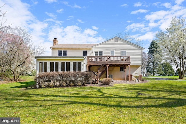 back of house with a wooden deck and a yard