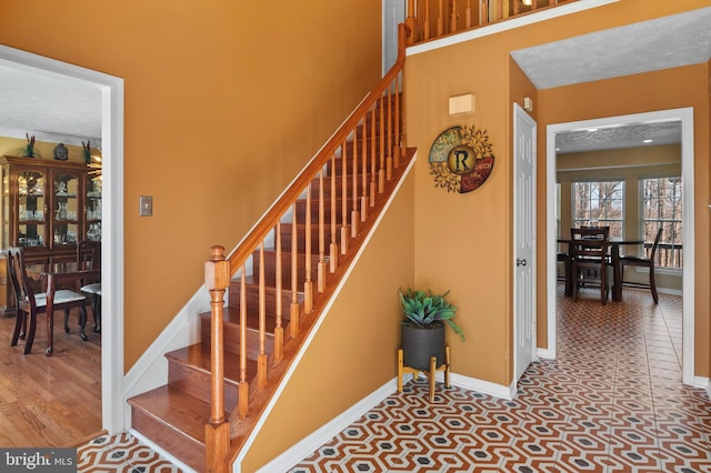 staircase with tile patterned floors