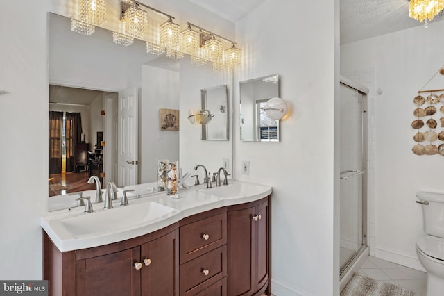 bathroom featuring tile patterned flooring, vanity, an enclosed shower, and toilet