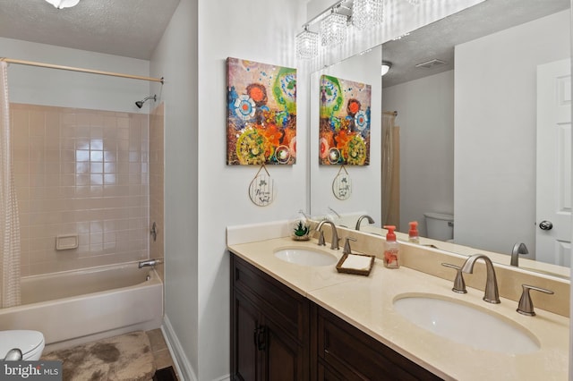 full bathroom with vanity, shower / tub combo, a textured ceiling, and toilet