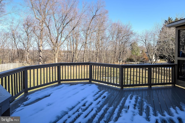 snow covered deck with a yard