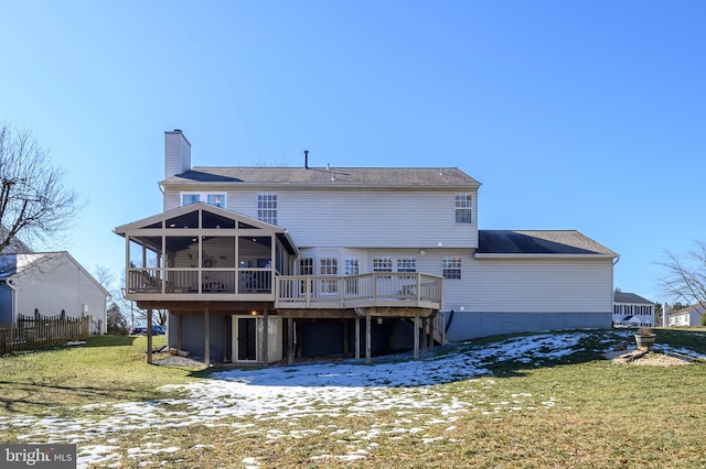 back of house with a wooden deck, a lawn, a sunroom, and ceiling fan