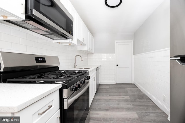 kitchen with sink, white cabinets, and appliances with stainless steel finishes