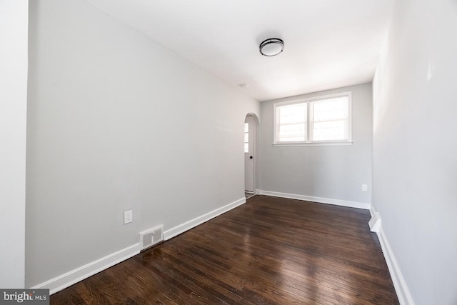 spare room with dark hardwood / wood-style floors