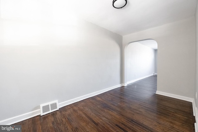 unfurnished room featuring dark hardwood / wood-style flooring