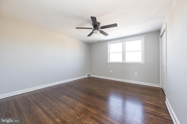 unfurnished room with dark hardwood / wood-style floors and ceiling fan