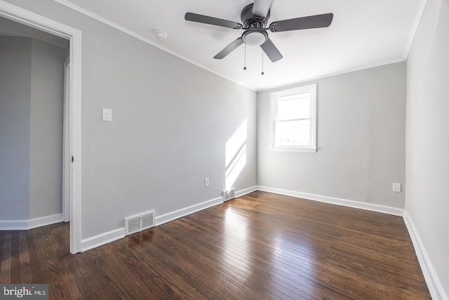 empty room featuring dark hardwood / wood-style flooring, crown molding, and ceiling fan