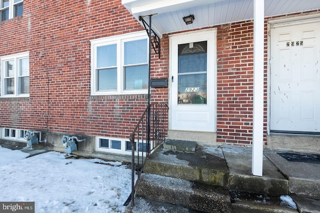 view of snow covered property entrance