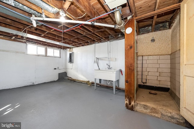 basement with electric panel and sink