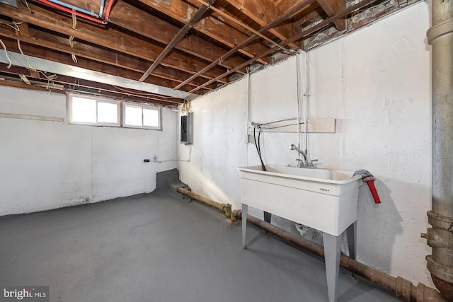 basement featuring sink and electric panel