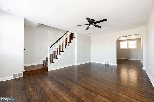 unfurnished living room with dark wood-type flooring and ceiling fan