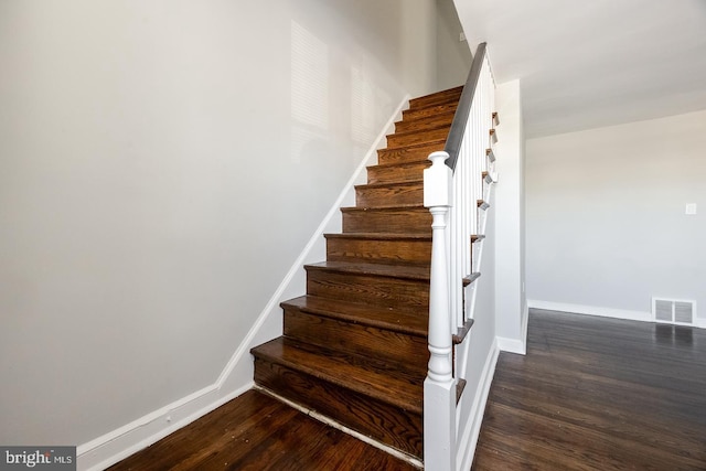 staircase with hardwood / wood-style floors