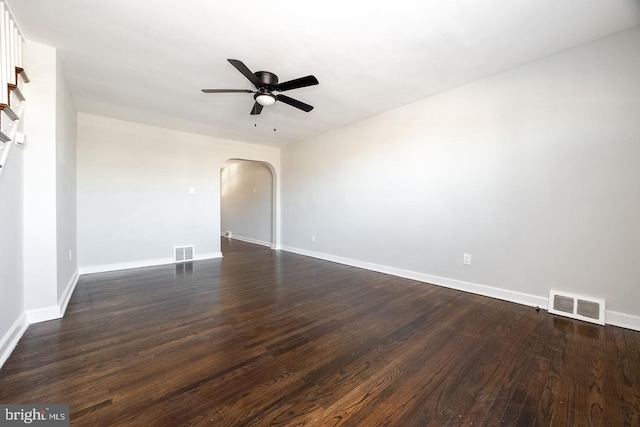 empty room with ceiling fan and dark hardwood / wood-style flooring