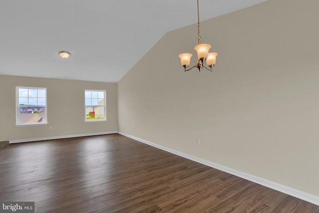 unfurnished room featuring an inviting chandelier, dark hardwood / wood-style flooring, and vaulted ceiling