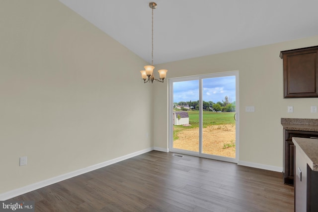 unfurnished dining area with wood-type flooring, vaulted ceiling, and a notable chandelier