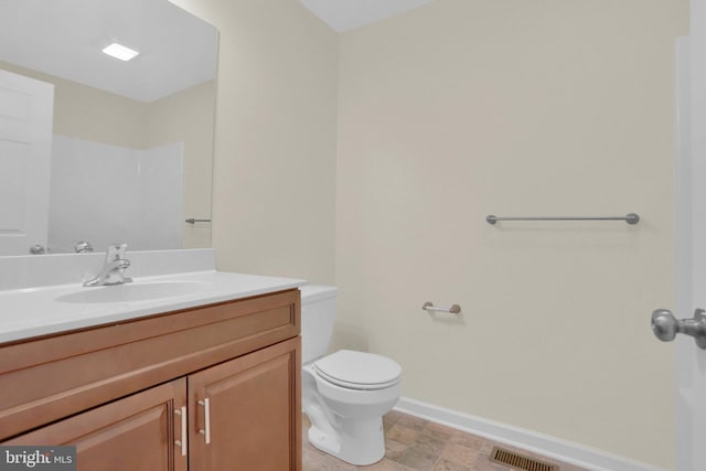 bathroom featuring vanity and toilet