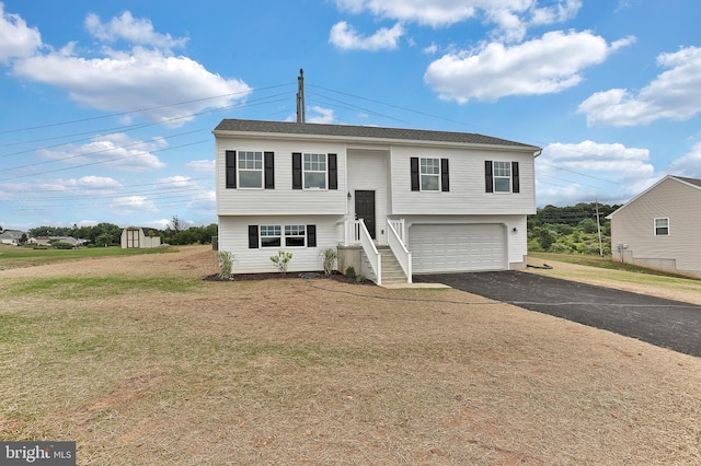 split foyer home with a garage and a front yard