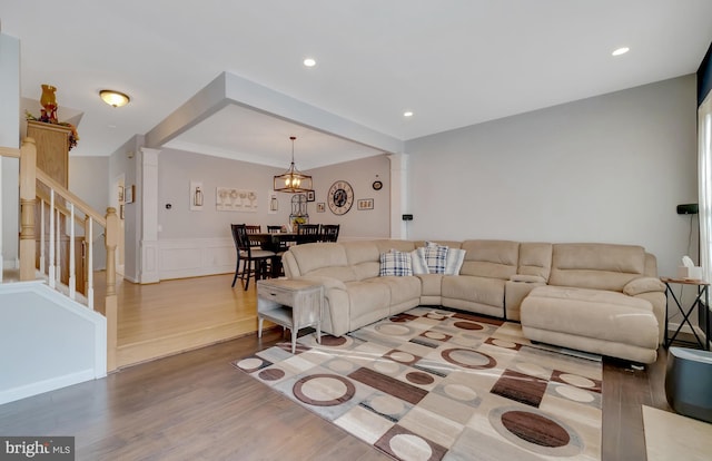 living room featuring decorative columns and hardwood / wood-style floors