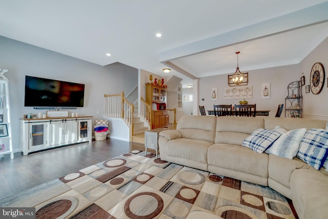 living room featuring hardwood / wood-style floors, a notable chandelier, and ornamental molding