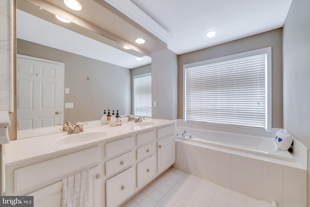 bathroom featuring vanity, tile patterned flooring, and a relaxing tiled tub