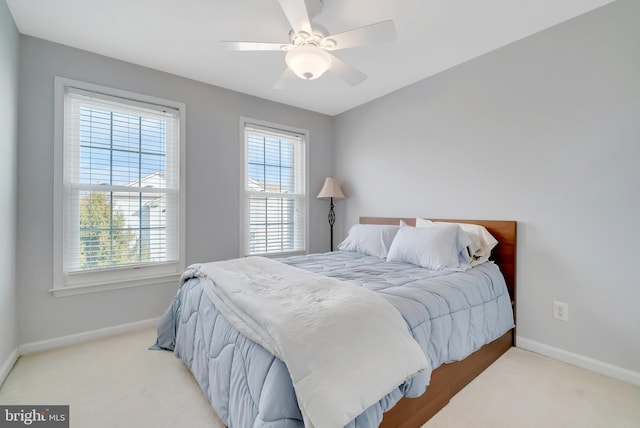 bedroom featuring light carpet and ceiling fan