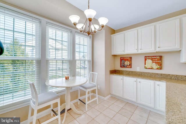 tiled dining space featuring an inviting chandelier