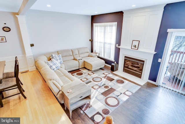 living room featuring a large fireplace and light hardwood / wood-style floors