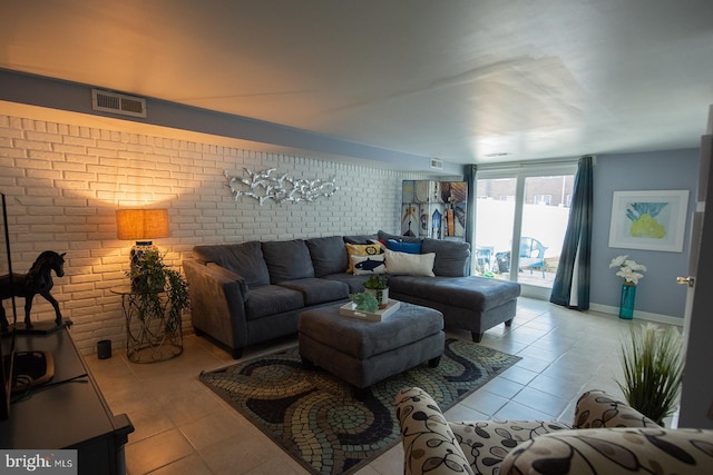 tiled living room with brick wall