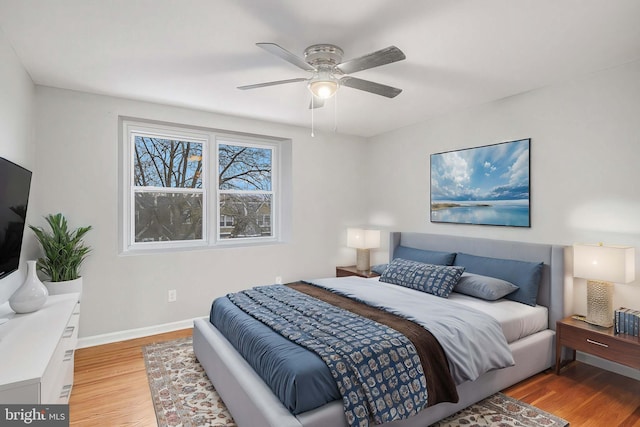 bedroom with ceiling fan and light hardwood / wood-style flooring