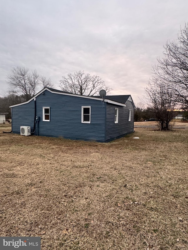 view of property exterior with a yard and ac unit