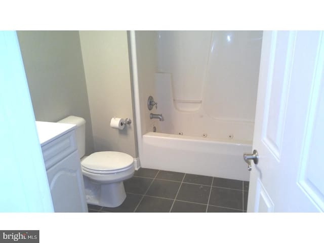 full bathroom featuring bathtub / shower combination, vanity, toilet, and tile patterned flooring