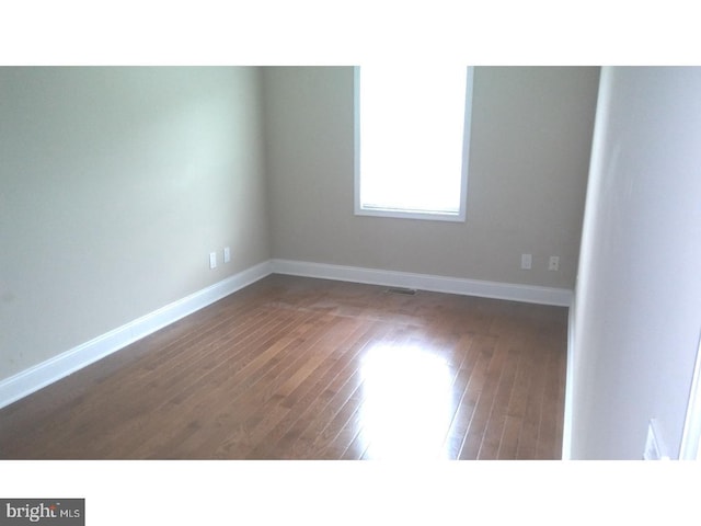 empty room featuring dark hardwood / wood-style floors