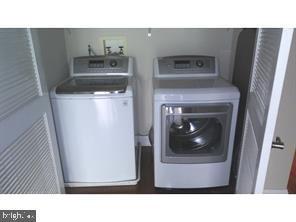 clothes washing area featuring washer and dryer