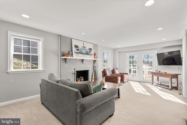 carpeted living room featuring a fireplace and french doors