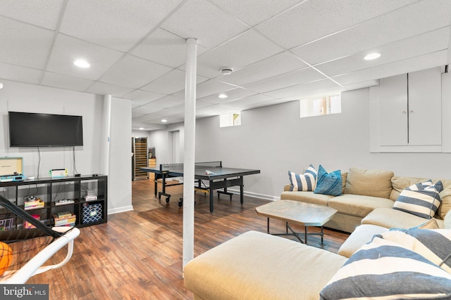 living room with wood-type flooring and a paneled ceiling