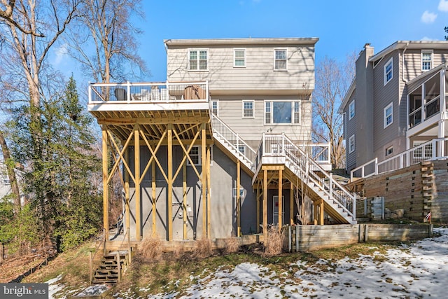 snow covered property with a wooden deck