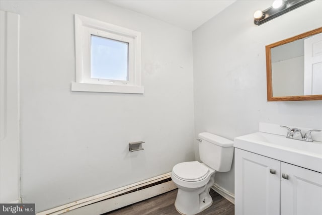 bathroom with toilet, wood finished floors, a baseboard radiator, baseboards, and vanity