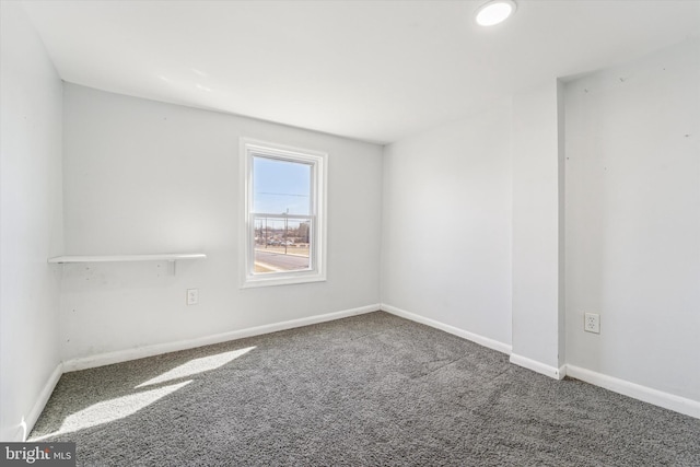 unfurnished room featuring carpet flooring and baseboards